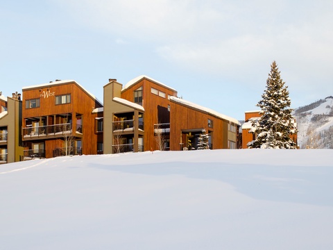 Mountain lodge property with warm wood architecture nestled in pristine snow, offering ski-in access and stunning alpine views. A classic winter retreat in a premier ski destination.