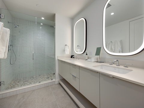 Refresh in your sleek ensuite with its sparkling walk-in shower, double vanity, and radiant backlit mirrors—everything you need to start your day feeling pampered and polished.
