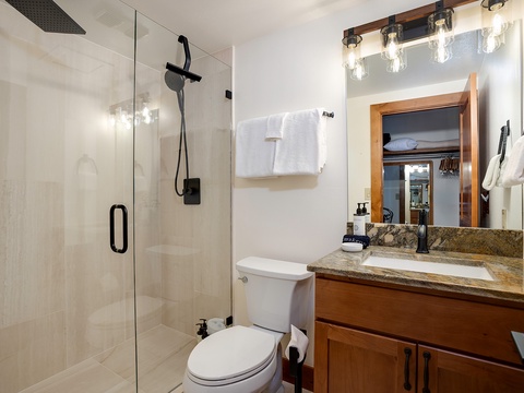 Step into your beautifully updated bathroom, where warm wood tones and elegant granite create a spa-like retreat. Fresh towels await, and the spacious walk-in shower invites you to unwind after a day of adventure.