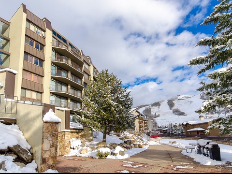 The property nestled in a scenic alpine ski village, surrounded by snowy slopes and mountain views, offers a perfect winter retreat location.