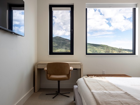 Wake up to stunning mountain views framing your bedroom windows. This peaceful space invites you to start each morning surrounded by natural beauty and fresh alpine air.