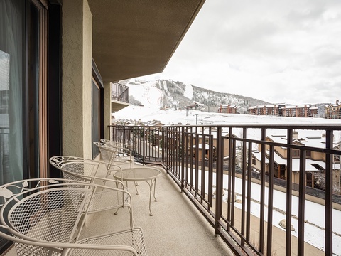 The balcony overlooks snow-covered slopes and mountain views—a perfect spot for your morning coffee or après-ski relaxation with the alpine scenery as your backdrop.