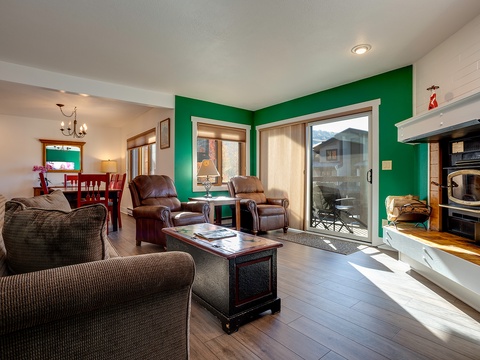 Sink into plush seating by your cozy fireplace and unwind with mountain views through sliding glass doors. This inviting living space connects you to both comfort and adventure.