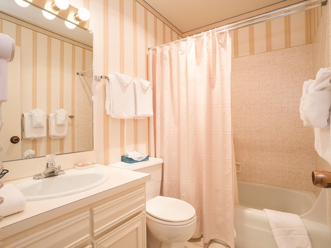 Your private bathroom features a tub-shower combo, vanity with mirror, and fresh towels, making it easy to refresh after a day of exploring.