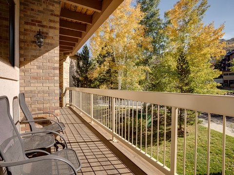 Step onto your private balcony and take in vibrant autumn foliage framing mountain views. Unwind in comfy lounge chairs while crisp air and golden leaves create the perfect escape.