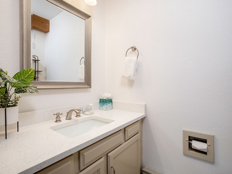 Your private bathroom features a spacious vanity with a clean quartz countertop, fresh linens, and a calming neutral palette—a peaceful retreat after your day's adventures.