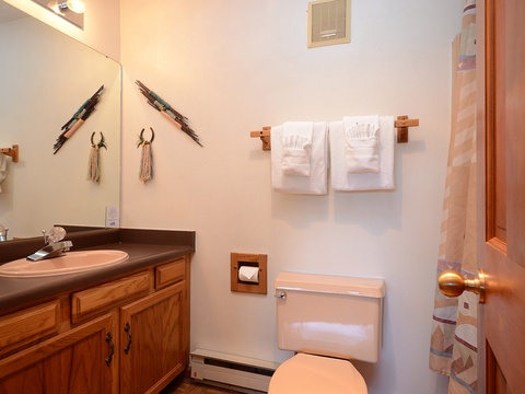 Your private bathroom features southwestern charm with artisan wall decor, fresh towels, and warm wood accents for a cozy, home-away-from-home feel.