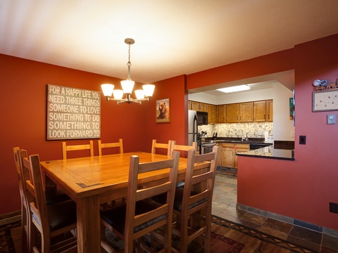Gather around this welcoming dining table for family meals and laughter, with the fully-equipped kitchen just steps away to bring everyone together effortlessly.