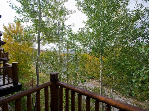 From this private balcony, colorful aspens frame peaceful lake views—a perfect spot for your morning coffee or evening reflection.