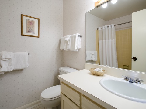 Your private bathroom features fresh towels, a spacious vanity, and everything you need to feel refreshed and ready for the day ahead.