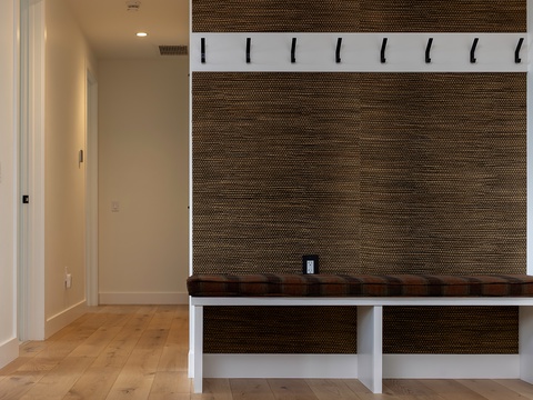A thoughtfully designed entryway with a built-in bench and hooks offers you a convenient spot to store your gear and unwind after a day of adventure.
