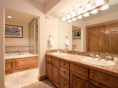 Indulge in your private spa-like retreat with dual sinks, elegant granite countertops, and a soaking tub that invites you to unwind after a day of adventure.