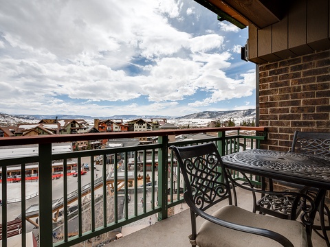 Perch on your private balcony with a warm drink and watch the world below, as mountain peaks frame the horizon and clouds drift overhead—this is your peaceful alpine retreat.