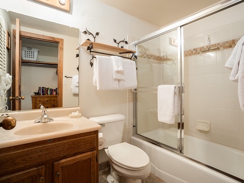Your private bathroom features fresh towels, a tub-shower combo, and charming rustic touches for a comfortable stay.