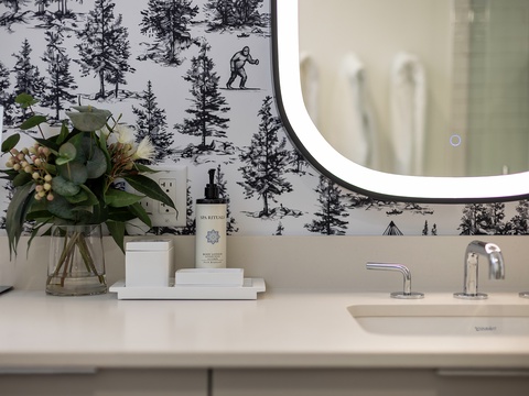 Step into your beautifully styled bathroom, where modern elegance meets thoughtful detail—featuring a sleek illuminated mirror and luxurious spa-quality amenities waiting for you.