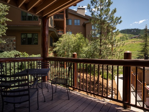 Sip your morning coffee on this private deck overlooking serene mountain slopes, with comfortable seating and fresh alpine air welcoming you to start each day outdoors.
