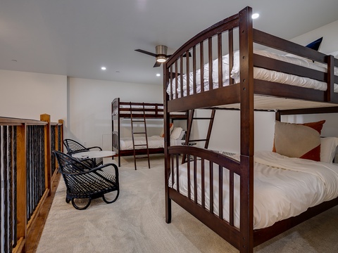 Cozy bunk room for the whole crew, complete with a stylish seating nook where you can relax after a day of adventure.