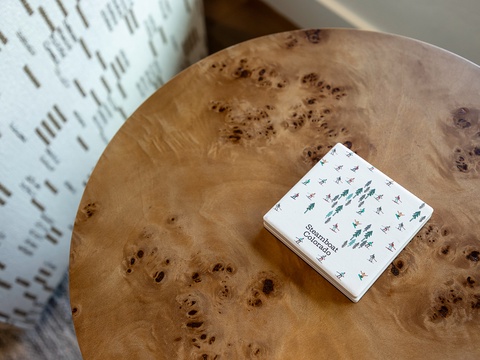 A beautifully crafted burl wood table awaits you, its rich grain and warm tones creating a welcoming focal point for your stay.