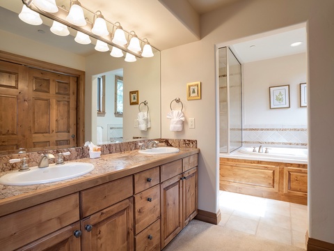 Refresh in your private bathroom with dual sinks, granite counters, and a separate soaking tub area perfect for unwinding after your mountain adventures.