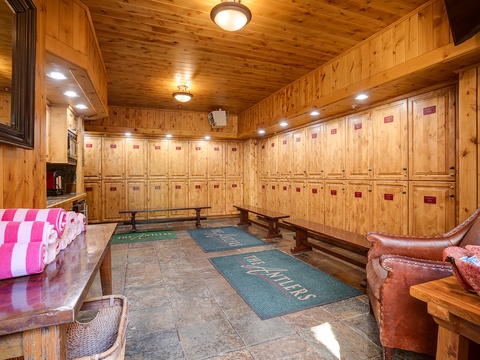 Your own private ski locker room with secure storage, plush seating, and warm wood throughout—everything you need to gear up in comfort.