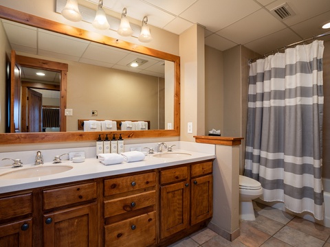 Unwind in your private bathroom with two sinks, plush towels, and a spacious shower—perfect for refreshing after a day of adventure.