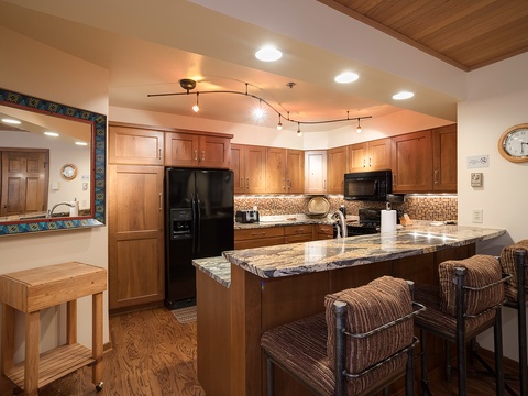 Your fully-equipped kitchen features warm wood cabinetry, granite countertops, and a welcoming breakfast bar—perfect for preparing meals and gathering with loved ones.