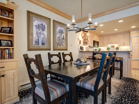 Gather around this inviting dining table with room for the whole group, opening directly to your fully equipped kitchen for easy entertaining and shared meals.