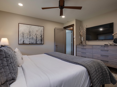 Sink into plush bedding and unwind in your private retreat, where modern elegance meets comfort. A ceiling fan keeps you cool while soft lighting sets the perfect mood for relaxation.
