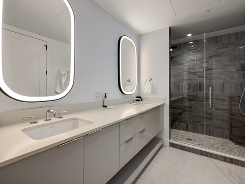 Step into your private spa-like retreat. Dual vanities with backlit mirrors and a spacious walk-in shower promise the perfect start and end to each day.