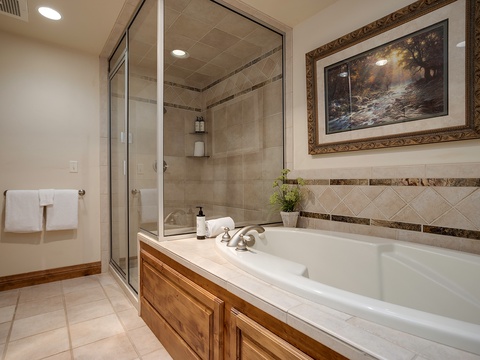 Soak away your cares in this elegant soaking tub, or refresh yourself in the spacious walk-in shower. Plush towels and warm tile details create your private spa retreat.