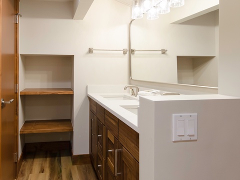 A clean, modern bathroom with dual sinks and ample counter space offers everything you need to freshen up comfortably during your stay.
