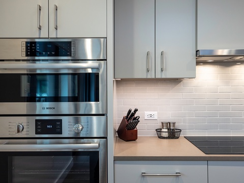 Fully equipped kitchen with stainless steel Bosch appliances, sleek cabinetry, and stylish subway tile backsplash—ready for your culinary adventures.