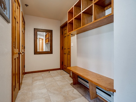 A welcoming mudroom provides built-in storage cubbies and a sturdy bench—perfect for organizing your gear after a day of mountain adventures.