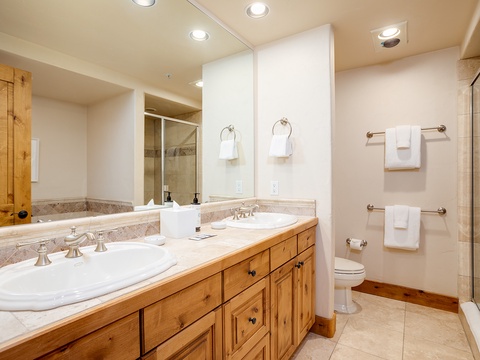 Unwind in your beautifully appointed bathroom with double vanities, elegant stone counters, a walk-in shower, and plush towels awaiting you.
