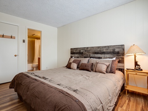 Settle into this cozy bedroom with its handsome reclaimed wood headboard, soft linens, and warm lighting—your peaceful retreat after a day of adventure.