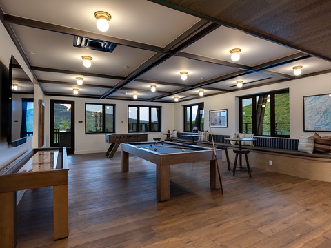 Your private game room awaits with stunning mountain views—challenge friends to billiards or shuffleboard while soaking in the natural beauty through every window.