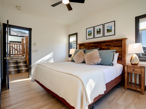 Sink into crisp linens and rustic charm as natural light fills your serene mountain retreat. The plush bed promises restful nights, while the private balcony invites you to start mornings with fresh alpine air.