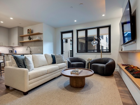 Step into your bright, open-concept retreat where modern design meets mountain comfort. Sink into plush seating by the fireplace, unwind with your favorite show, and enjoy effortless living in this stylish space.