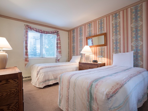 Unwind in your cozy twin bedroom, featuring warm wood furnishings, soft ambient lighting, and charming southwestern-inspired décor that creates a welcoming retreat after your day's adventures.