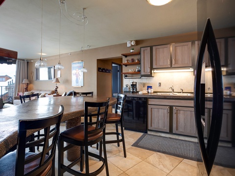 Your open-concept kitchen and dining space invites you to gather around the large island or cozy dining table, all flooded with natural light and ready for memorable meals together.