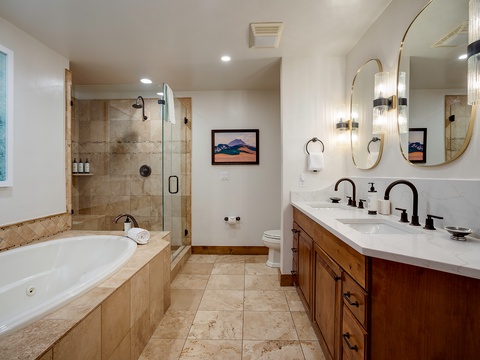 Refresh and recharge in your private sanctuary, where a deep soaking tub, walk-in rainfall shower, and dual vanities await to pamper you after a day of adventure.