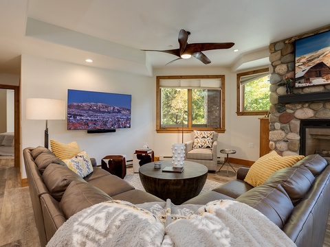 Sink into plush leather sofas in your bright, inviting living room. Warm up by the stone fireplace, relax with your favorite show, and enjoy mountain views through sunlit windows.