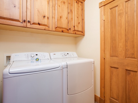 Your own washer and dryer make packing light a breeze, with warm knotty pine cabinets adding a cozy, homey touch to this convenient laundry space.