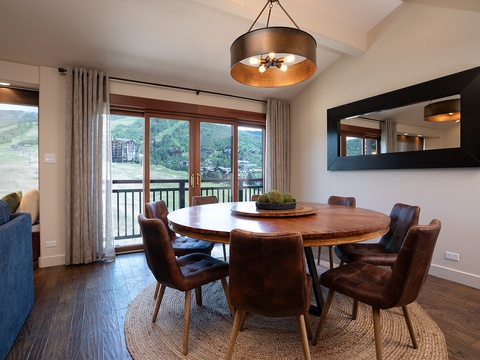 Gather around this beautifully crafted round table with mountain views framing your meals. The warm lighting and thoughtful design create an inviting space where your group can share stories and laughter.