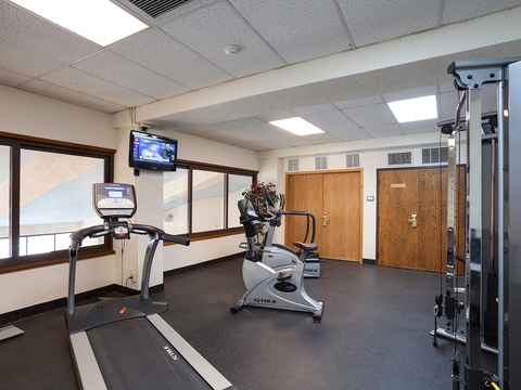 Stay active during your getaway in this well-equipped fitness center featuring cardio machines, strength training equipment, and natural light to energize your workouts.