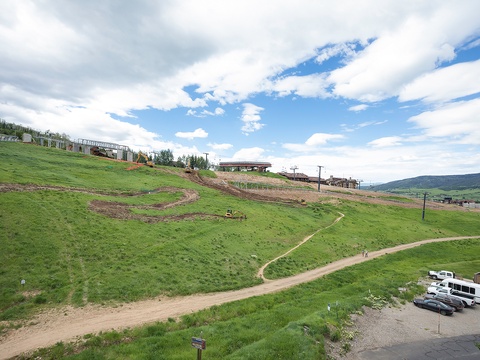 Scenic mountainside location with ski lifts and rolling hills, set in a year-round mountain resort community.