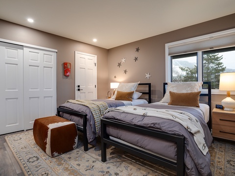 Two cozy twin beds await, perfect for kids or friends traveling together. Natural light fills the space, while whimsical star accents add a playful touch to your home-away-from-home.
