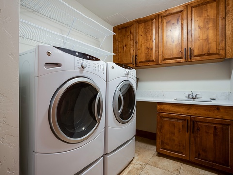 You'll love the convenience of your dedicated laundry room, complete with a full-size washer and dryer, ample storage cabinets, and a functional sink for easy stain treatment.