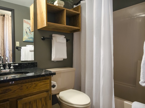 Your cozy bathroom features plush towels, natural wood accents, and everything you need to feel right at home during your stay.