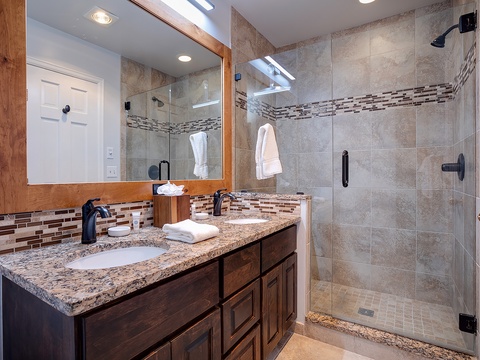 Step into your beautifully tiled en-suite with elegant granite counters, dual sinks, and a spacious walk-in shower—perfect for refreshing after your day's adventures.